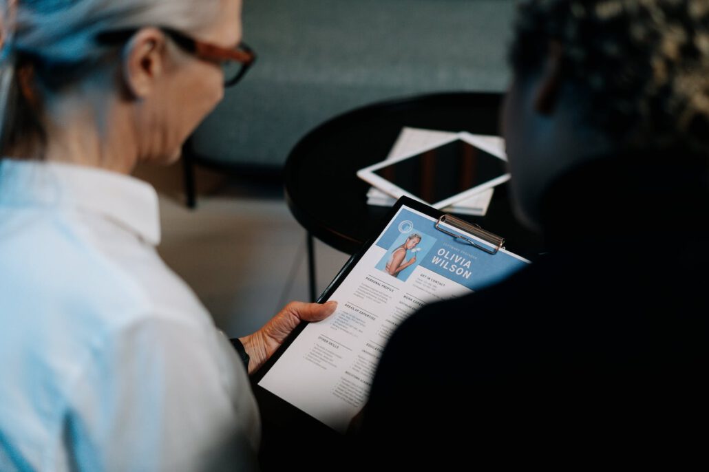 woman holding a clipboard with resume